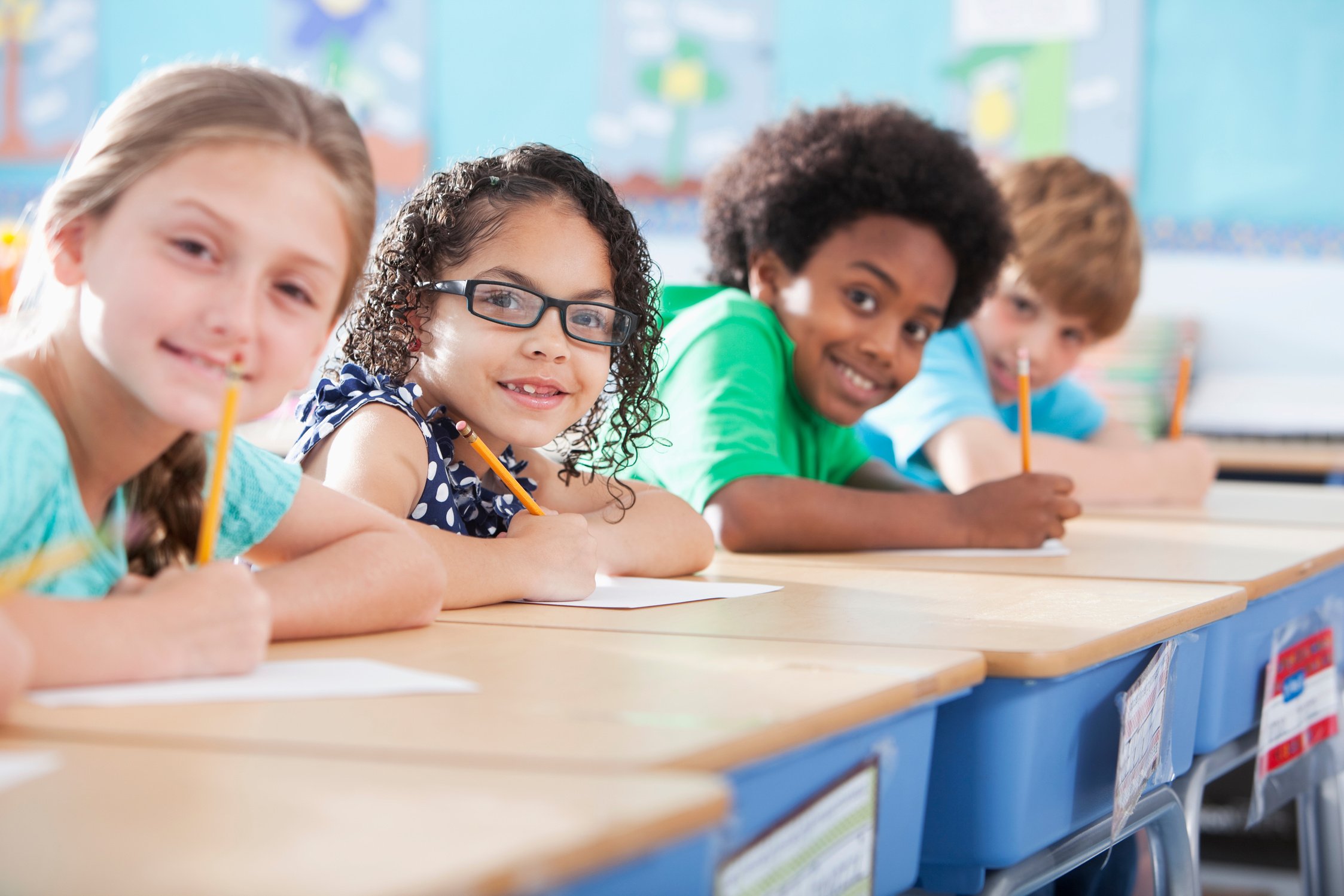 Elementary school children writing in class